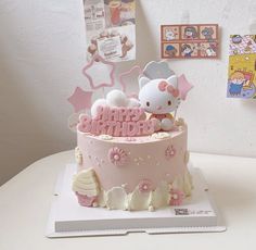 a hello kitty birthday cake on a table