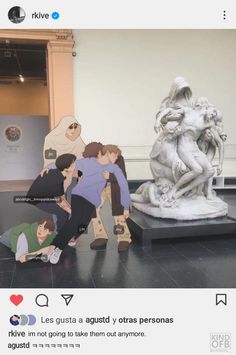 an image of people taking pictures in front of a statue that looks like they are hugging each other