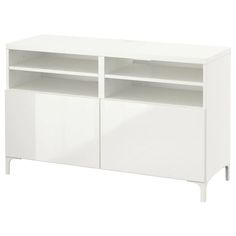 a white entertainment center with two doors and shelves on one side, in front of a white background