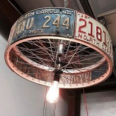 a light hanging from the ceiling in a building with an old sign on it's side