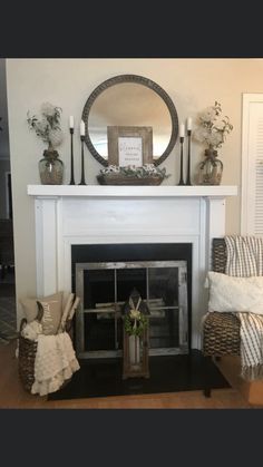 a living room filled with furniture and a fire place in front of a white fireplace