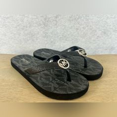 These Black Flip Flops From Michael Kors Are A Stylish Addition To Any Young Girl's Shoe Collection. The Signature Mk Pattern On The Straps Adds A Touch Of Sophistication, While The Flat Design Ensures Comfort For All-Day Wear. These Flip Flops Are Available In Size 13-1, Perfect For Growing Feet. Whether Paired With A Summer Dress Or Worn To The Beach, These Michael Kors Flip Flops Are A Must-Have For Any Fashion-Forward Young Girl. Gold Dress Shoes, Floral Flip Flops, Michael Kors Flats, Michael Kors Sandals, Michael Kors Bedford, Rainbow Sandals, Uniqlo Bags, Vintage Chanel Handbags