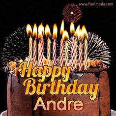 a birthday cake with lit candles on it and the words happy birthday andre written in gold