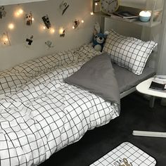 a bed room with a neatly made bed and pillows