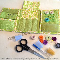 sewing supplies laid out on a table with scissors, buttons and other things to sew