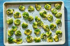 brussel sprouts on a baking sheet covered in parmesan cheese