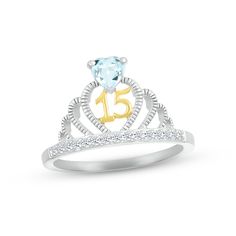 a diamond ring with the number fifteen on it's side and a heart shaped stone