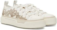 Find AMIRI Off-white & Glitter Stars Court Low Sneakers on Editorialist. Low-top cotton canvas sneakers in off-white. · Buffed leather trim throughout · Rubber cap toe · Lace-up closure · Logo flag at tongue · Gold-tone glittered graphic appliqués at sides · Pull-loop at heel collar · Buffed leather lining · Treaded rubber sole Supplier color: Gold