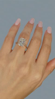 a woman's hand with a diamond ring on it