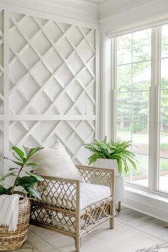 a living room with white walls and plants