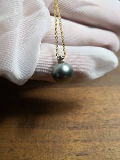 Genuine Tahitian black green 10mm pearl pendant. Pendant is setting with 18K gold and CZ stone. Necklace chain length is about 18 inches. 18K gold plated sterling silver Belcher chain. Gift box available. Yellow Gold Tahitian Pearl Necklace, Gold Tahitian Pearl Necklace For Anniversary, Formal Gold Necklace With Tahitian Pearl, Formal Gold Tahitian Pearl Necklace, Gold Tahitian Pearl Pendant Necklace, Cz Stone Necklace, Belcher Chain, Green Pearls, Necklace Chain Lengths