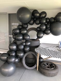 black balloons and tires are arranged on the floor