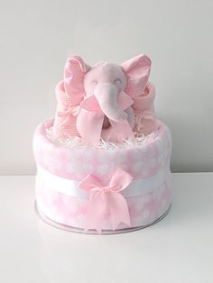 a pink and white cake with an elephant on top