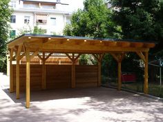 a wooden carport sitting in the middle of a park