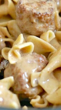 meatballs and noodles are being cooked in a skillet