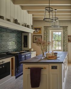 a large kitchen with an island in the middle