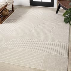 a white rug with circles on it in front of a door