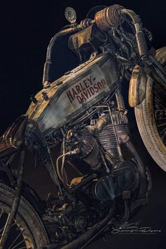 an antique harley davidson motorcycle parked in the dark