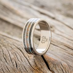 a wedding ring with two different colored wood inlays on it's side