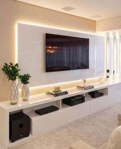 a large flat screen tv mounted to the side of a wall in a living room