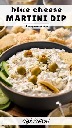 blue cheese martini dip in a bowl with crackers and cucumbers on the side