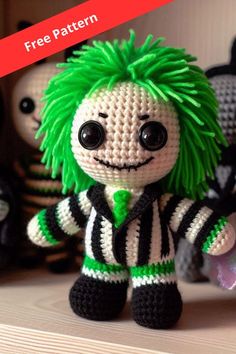 a crocheted doll with green hair sitting on a shelf next to other stuffed animals