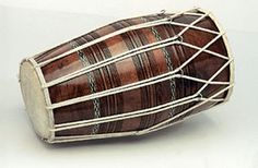 a wooden drum sitting on top of a white table