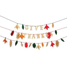 a banner that says give thanks and leaves hanging from a line with clothes pins attached to it