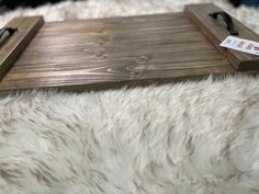 a wooden tray sitting on top of a white rug