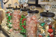 several glass jars filled with candy and candies