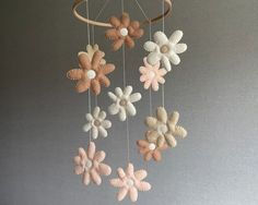 a mobile with flowers hanging from it's sides