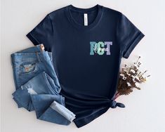 a t - shirt with the word hot on it next to some jeans and flowers