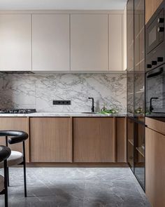 a kitchen with marble counter tops and wooden cabinets