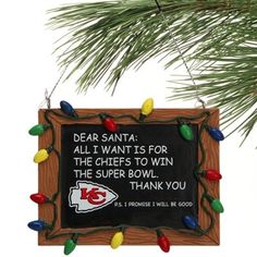 a chicago bears ornament hanging from a christmas tree with lights and saying dear santa all i want is for the bears to win the super bowl thank you