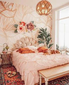 a cat laying on top of a bed in a room with floral wallpaper and rugs