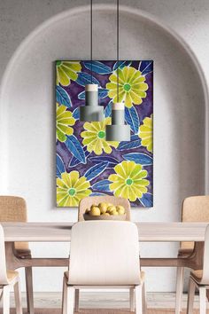 a dining room table and chairs in front of a painting on the wall with yellow flowers