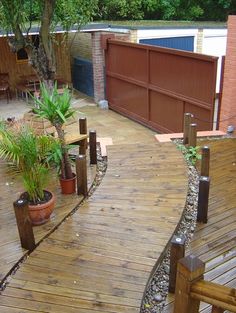 a wooden deck with potted plants on it