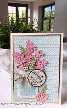 a card with pink flowers in a mason jar