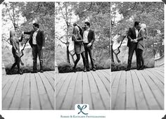 three men in suits are standing on a wooden deck and one man is looking at his phone