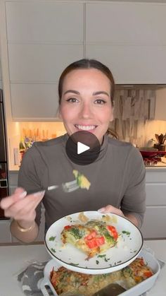 a woman holding a plate with food on it