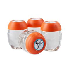 three orange and white baby bottles sitting next to each other