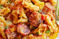 pasta with sausage and tomato sauce is shown in this image, it appears to be made from scratch