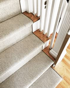 the stairs are lined with carpet and white railings