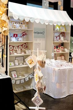 a display in a store filled with lots of cards and paper decorations on shelves next to a table