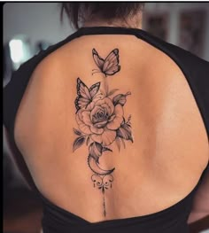 a woman with a butterfly and rose tattoo on her back