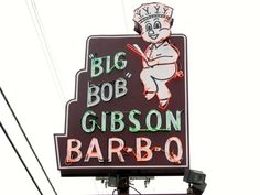 a neon sign for a bar with a chef on it's head and the words, big bob gibson bar - o