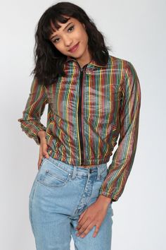 "Vintage 90s cropped Rainbow jacket with primary and secondary color stripes. Zips up the front. Tiny fit. Every garment we sell is authentic vintage and one-of-a-kind! You will receive the exact item photographed. Condition: Very good vintage. Best fits women's: Extra small Material: unknown. Feels like a cotton blend with a shiny polyurethane finish. MEASUREMENTS Taken from seam to seam while the garment is lying flat. Double the armpit, waist, and hips For reference, model is 5'10\" and measu Retro Multicolor Track Jacket For Fall, Trendy Rainbow Outerwear For Fall, 90s Style Multicolor Windbreaker For Spring, 90s Inspired Multicolor Long Sleeve Outerwear, Casual Multicolor Track Jacket For Fall, Retro Multicolor Windbreaker For Fall, Trendy Rainbow Long Sleeve Outerwear, 90s Style Multicolor Spring Outerwear, 90s Multicolor Spring Outerwear