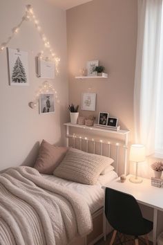 a white bed sitting under a window next to a desk