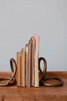 This gorgeous pair of brass bookends from Pepper + Vetiver features an abstract design and an antique brass finish for elegant accent to your bookshelves. Display your books with the beautiful Kairo Brass Bookends for an added warmth that will enhance your decor. Summer Lighting, Summer Rugs, Anchor Decor, Summer Furniture, Electric Clock, Anchor Chain, Tabletop Accessories, Creative Co Op, Taper Candle Holders