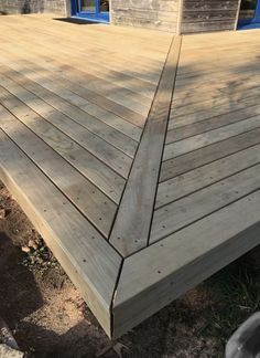 a wooden deck in front of a house